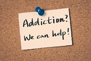 a sticky note on a cork board with the words addiction we can help on it