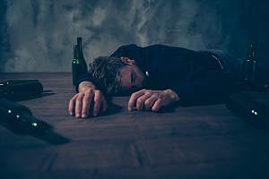 a man collapsed after binge drinking too much who needs to reach out for help
