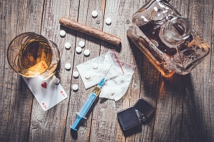 drugs and alcohol on a table representing different addictions