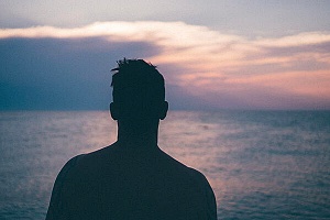 person overlooking the sea while thinking about help for his co-occuring disorder