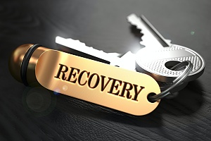 silver keys on a gold keychain that says recovery