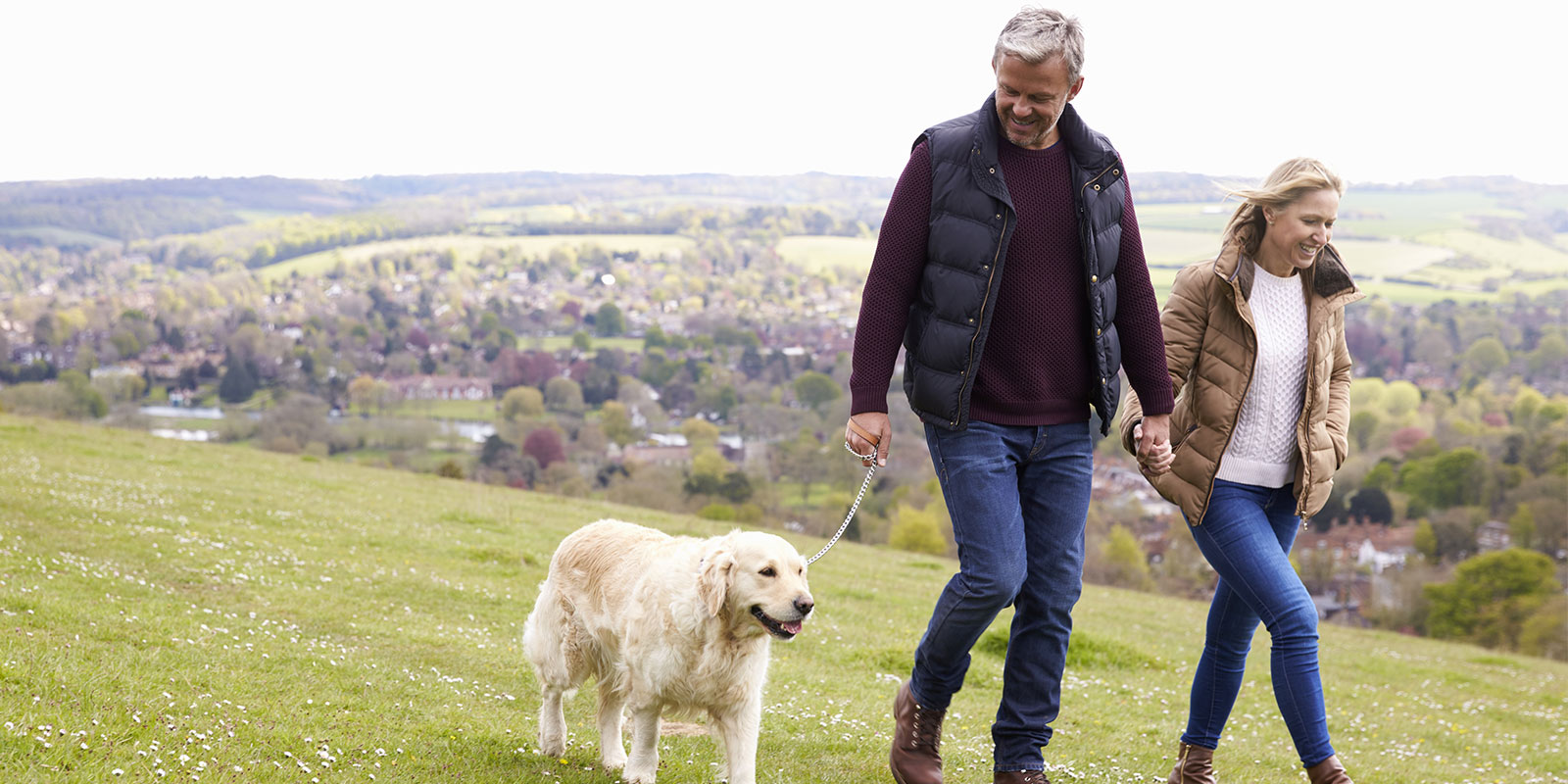 man and wife walking their dog after learning what Integrated Behavioral Model is