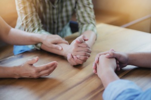 a family holding hands in a Family Recovery Program