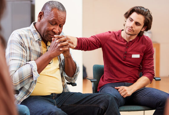 men comforting another in substance abuse group therapy activities