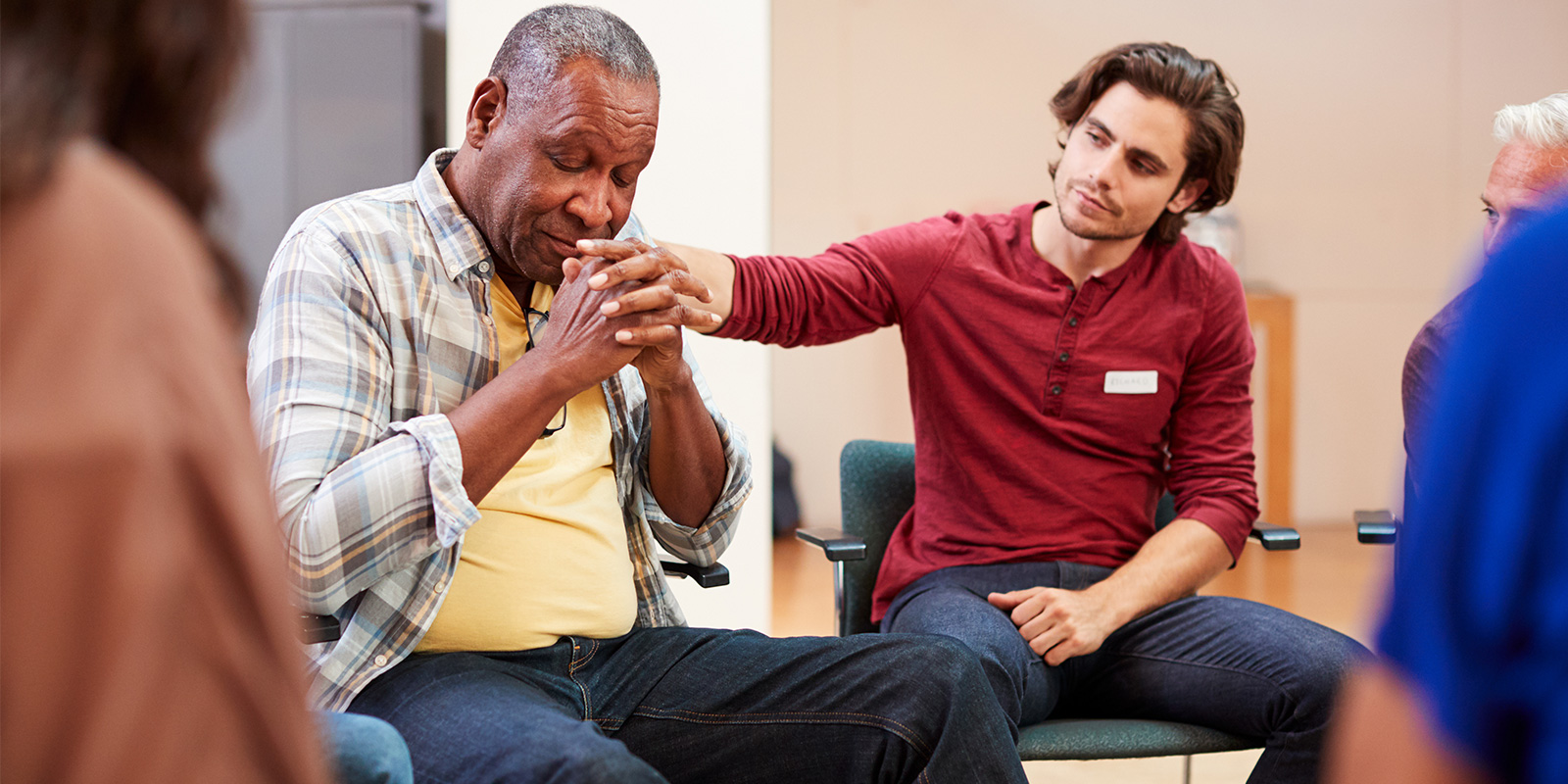 men comforting another in substance abuse group therapy activities