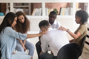 back view of diverse people sit in circle at psychological therapy session during Outpatient Drug Treatment Programs