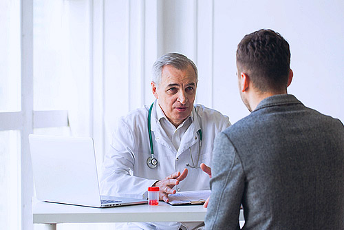 a doctor speaking with an addiction recovery patient in integrated care