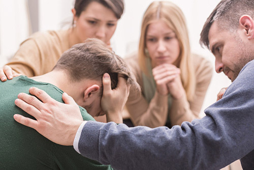 a family consoling each other in a DC family recovery program