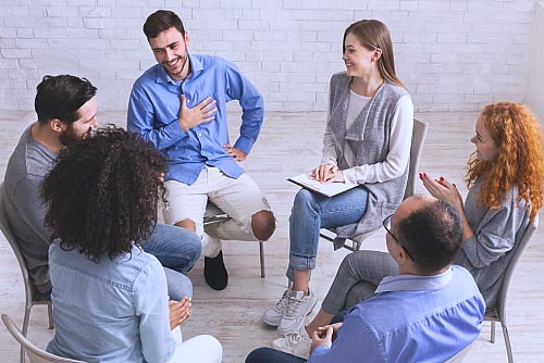 a group speaking to each other in an outpatient program