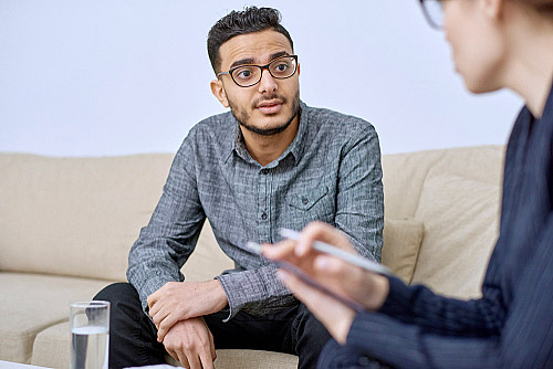 a man speaking with a professional in individual therapy for addiction recovery
