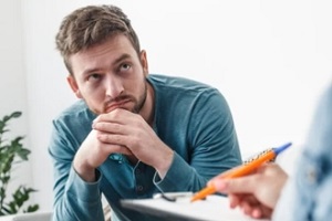 man discussing drugs problems with counseller