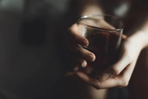 women holding alcohol glass