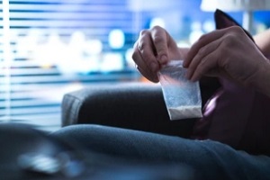 man holding cocaine in hand