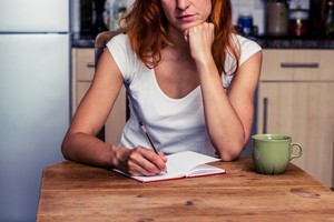 Woman brainstorming and making list