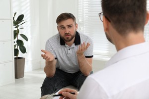 Man with therapist during outpatient alcohol treatment