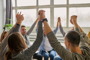 A group of people is holding each other's hands in the air