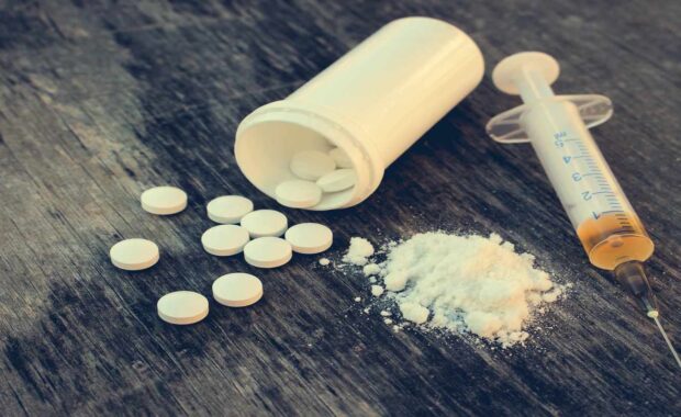 Tablets, cocaine, and the liquid drug on the floor