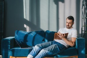 A man setting SMART CBT goal while sitting on a couch