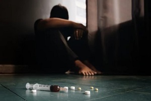 addicted person with tablets and injection on the floor in Northern Virginia