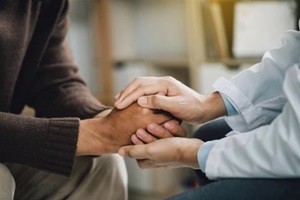 comforts an anxious depression patient for medical treatment in diagnostic room