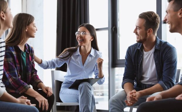 DC psychotherapist working with patients in group therapy session indoors