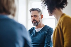 midsection of men and women sitting in a circle during Washington DC IOP group therapy