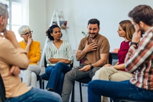 upset man told his problems, looking emotional during the group therapy