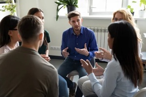 diverse people seated in circle participating at IOP group therapy session in Washington DC