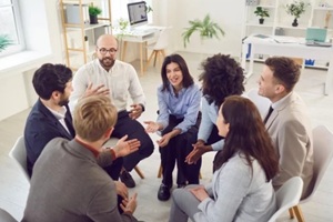 young addict people talking on group therapy meeting, sitting in circle
