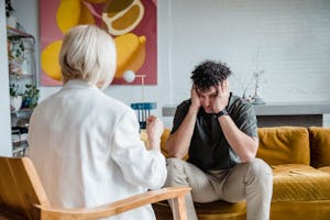 Man sitting on couch n Front of a DC Therapist