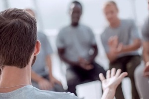 young people are discussing something sitting in a circle