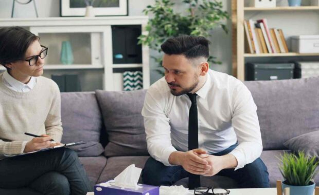 Professional Man Talking to Therapist about Career Stress