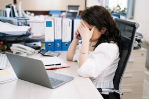 Stressed Female Employee Talking on Phone in DC office