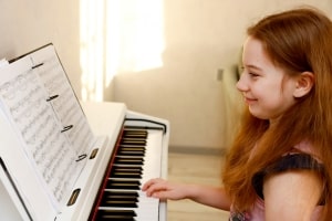 Happy Girl Child Playing Piano