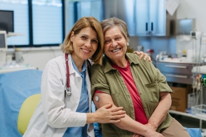 Young Female Doctor and Mentally Challenged Older Patient Smiling Together