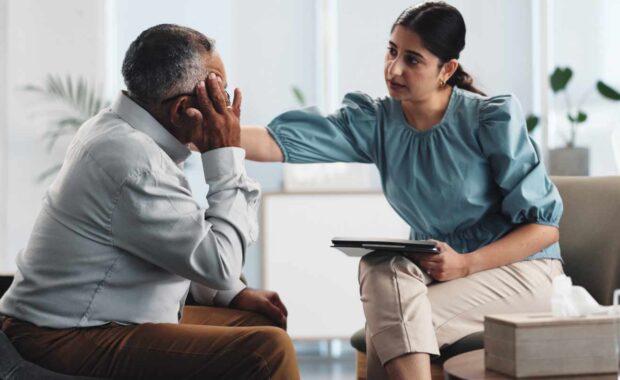 Adult Mental Health Service Therapist Comforting an Elderly Patient
