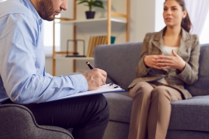 Therapist Writing Information on Notepad while Talking to A Patient in Indivisual Therapy