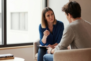 Female Therapist Talking to Adult Boy for Consistent Therapy Sessions