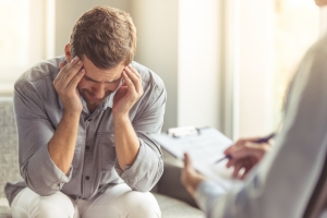 Man Experiencing Mental Trauma Having Indivisual Therapy
