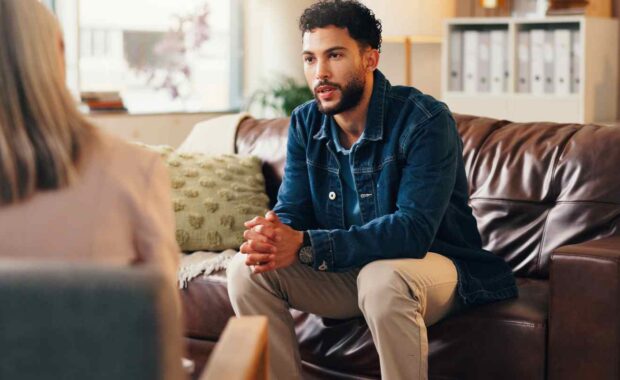 Young Man Explaining His Mental Health Problems to a Therapist