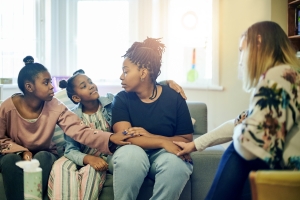 Family Members Supporting Stressed Woman at Home