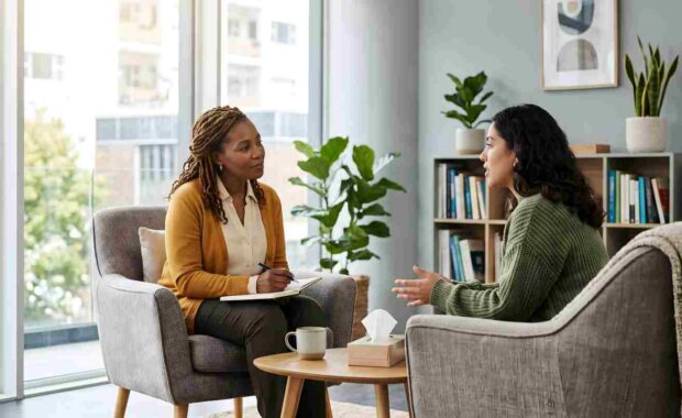 Professional Therapist Listening to Stressed Patient in Therapy Session