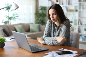 Woman Lost in Sad Thoughts While Working on Laptop Sign of Emotional Stress